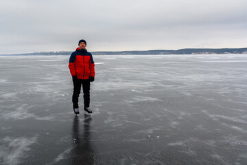 A brave skater in the widest and deepest part of the Volga River near Ulyanovsk. Skating on natural bodies of water.