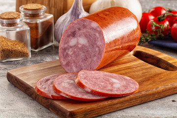 Ham sausage with slice over board