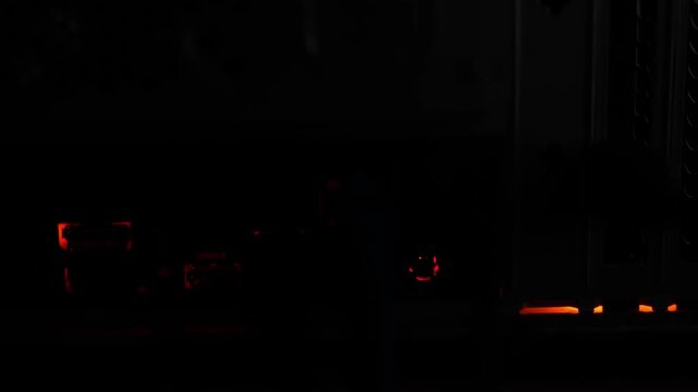 The back panel of the computer's system unit, the Internet port blinks in the dark