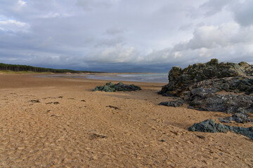 An almost deserted Newborough Beach at low tide on Anglesey, Wales.