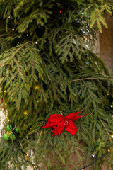 Christmas tree with many ornaments and pine cones. tree is decorated with gold and white ornaments.