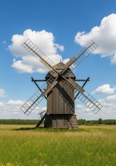 Fototapeta premium Old Wooden Windmill in Summer Field - A rustic wooden windmill stands tall in a grassy field under a bright blue sky, symbolizing heritage, tradition, agriculture, energy, and rural landscapes