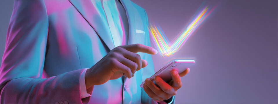 A person in a suit using a smartphone with glowing effects above it.