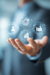 Fototapeta premium Icons hovering over a hand showing performance and progress indicators.