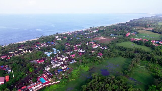Colva Beach with greenery and hotels at goa. day time, Trucking Shot, drone shot, 4k.