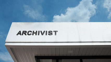 Archivist word sign displayed on building facade under clear blue sky, symbolizing record keeping, documentation, and archival management