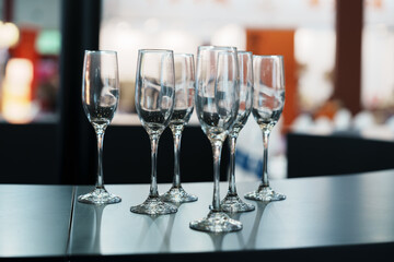 Empty champagne glasses arranged on the bar