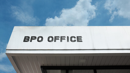 BPO Office word sign displayed on building under clear blue sky, representing business process outsourcing, corporate work, office environment, and services