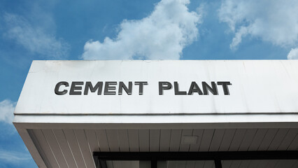 Cement Plant word sign displayed on a building under a clear blue sky, representing construction materials, manufacturing, industrial production, and factory facilities
