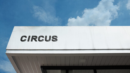 Circus word sign displayed on a building under a clear blue sky, representing entertainment, performance arts, acrobatics, shows, and cultural amusement facilities