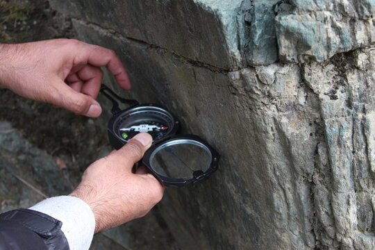 Geologist Measuring Rock Dip and Strike with Brunton Compass in Northern Pakistan