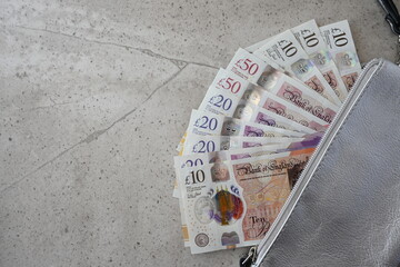Silver partmone with british pound money. United Kindom bills in leather wallet for commerce concept.