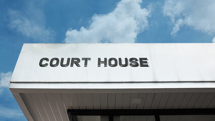 Naklejka premium Court House word sign displayed on a building under a clear blue sky, representing legal services, judiciary, law enforcement, public administration, and government facilities