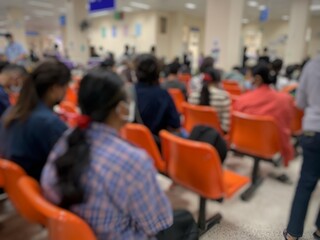 Many patients are sitting and waiting to see a doctor in the hospital.