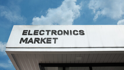 Electronics Market sign displayed on a building against a clear blue sky, symbolizing technology retail, consumer gadgets, digital commerce, commercial business, trading hub, and shopping