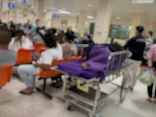Many patients are sitting and waiting to see a doctor in the hospital.
