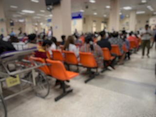 Many patients are sitting and waiting to see a doctor in the hospital.