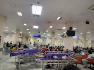 Many patients sit and lie on wheelchairs and stretchers in the hospital.