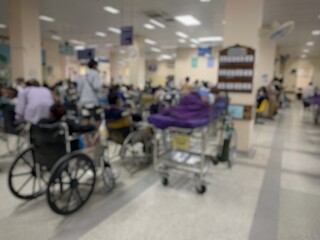 Many patients sit and lie on wheelchairs and stretchers in the hospital.