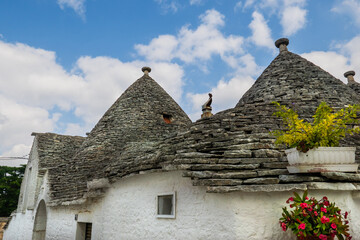 Traditional trulli houses.  Conical roofs made of stone slabs. Alberobello, province of Bari, Puglia region, Italy