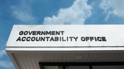 Obraz premium Government Accountability Office sign displayed on a building against a clear blue sky, symbolizing oversight, auditing, public finance, official investigation, and transparency