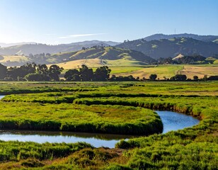 Serene winding river flowing through lush green valley with rolling hills background