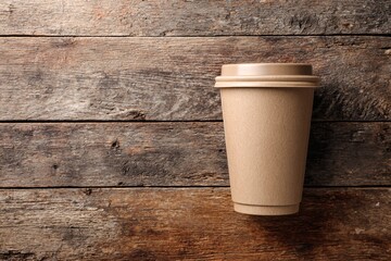 Blank kraft paper coffee cup flat lay on rustic wood table, sustainable takeaway mockup for branding design.