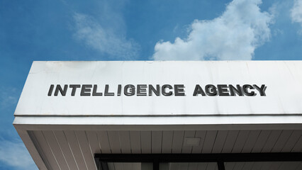 Intelligence Agency sign on a building against a clear blue sky, symbolizing government secrecy, national security, espionage, information, and mission