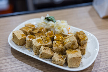 Hot stinky tofu with side of pickled cabbage