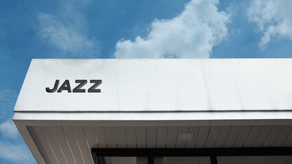 Jazz sign on a building against a clear blue sky, symbolizing music genre, performance venue, culture, improvisation, entertainment, and blues