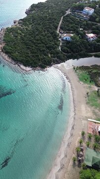 Aerial view of Maladroxia beach with turquoise water and coastal village