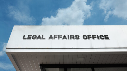 Fototapeta premium Legal Affairs Office sign on a building against a clear blue sky, symbolizing governmental body, legal consultation, policy regulation, administrative justice, and law