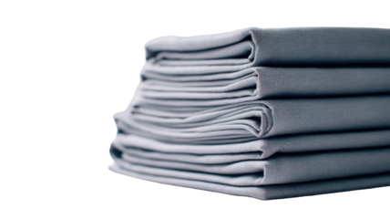 Neatly stacked folded gray bed sheets arranged in an organized pile showcasing clean textile layers on white background