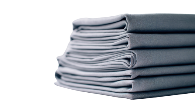 Neatly stacked folded gray bed sheets arranged in an organized pile showcasing clean textile layers on white background