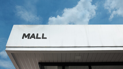 Mall House sign on a building against a clear blue sky, symbolizing retail shopping, consumer commerce, entertainment complex, urban development, and leisure