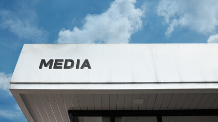 Media sign on a building against a clear blue sky, symbolizing communication, information dissemination, broadcasting, news production, technology, and press