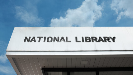 Obraz premium National Library sign on a building against a clear blue sky, symbolizing literature collection, national knowledge, cultural heritage, public reading, research center, and resource