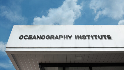 Oceanography Institute word signage on a research building under a blue sky, symbolizing marine science, education, environmental study, and aquatic discovery