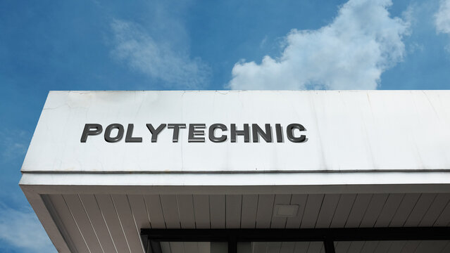Polytechnic word signage on an educational building under a blue sky, symbolizing technical learning, vocational training, engineering, and higher education