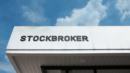 Stockbroker word signage on a commercial or financial building under a blue sky, symbolizing investment advisory, financial service, trading, market dealing, wealth management, and brokerage office
