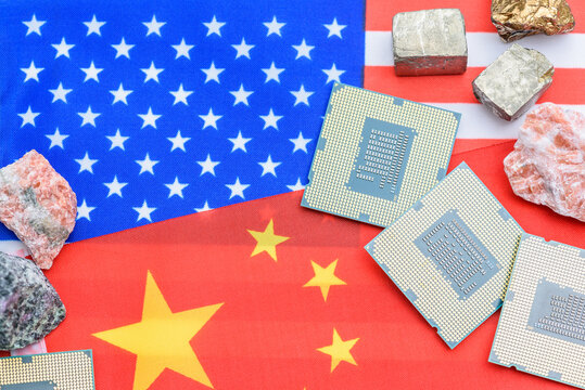 Rare earth minerals and CPUs on the US&ndash;China flags highlight intensifying semiconductor restrictions and future strategic resource competition amid global tech tensions.
