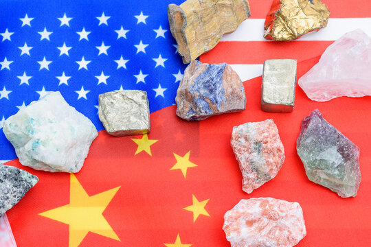 US and China Trade War Concept with Critical Minerals and Rare Earth Elements on Flags