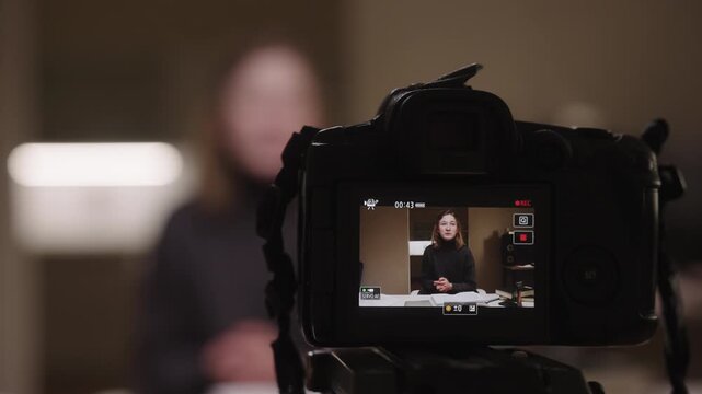 View from the recording camera of female vlogger with cerebral palsy and spasticity energetically gesturing and speaking while vlogging about journey, empowerment and inclusive everyday life at home.