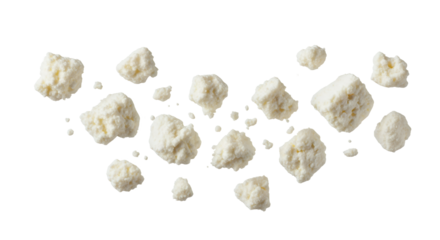 Scattered feta crumbles on a clean surface present a visually interesting texture and pattern composition with a focus on food delicacy