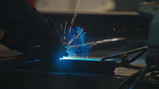 Close-Up of Worker Welding with Bright Sparks