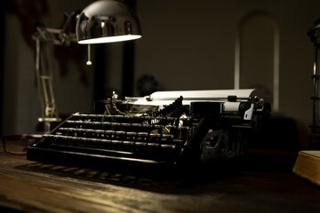 Vintage typewriter and desk lamp create a nostalgic writing atmosphere in a cozy indoor workspace...