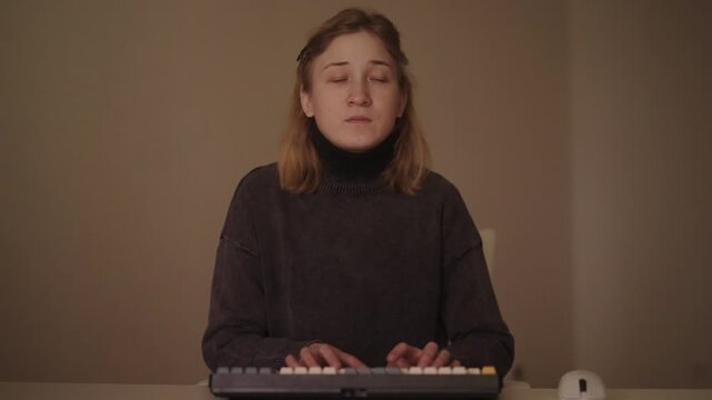 Portrait of focused businesswoman with cerebral palsy using computer, typing on keyboard and using mouse. Concept of disability, inclusion, accessibility, technology and overcoming challenges at work.