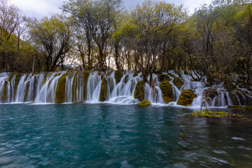The  Arrow Bamboo Lake Waterfall in Jiuzhaigou National Park is a famous tourist attraction in Sichuan, especially during the autumn leaves season, China