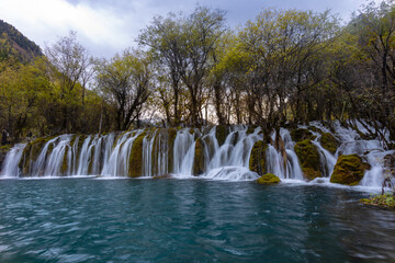 The  Arrow Bamboo Lake Waterfall in Jiuzhaigou National Park is a famous tourist attraction in Sichuan, especially during the autumn leaves season, China