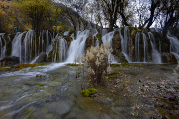 The  Arrow Bamboo Lake Waterfall in Jiuzhaigou National Park is a famous tourist attraction in Sichuan, especially during the autumn leaves season, China